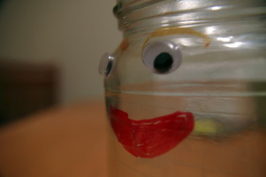 Glass jar with face