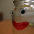 Glass jar with face